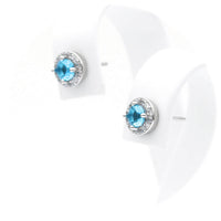 Ασημένια σκουλαρίκια ροζέτες σε στρογγυλό σχήμα με γαλάζιες πέτρες ζιργκόν